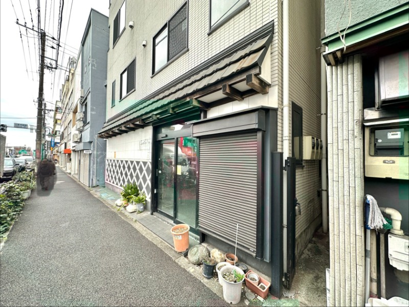 駅出口より環状８号線越しに視認。多摩美術大学や五島美術館の訪問客様にて来客履歴あり。バス停「上野毛駅前」歩道斜め前に立地 (202415)